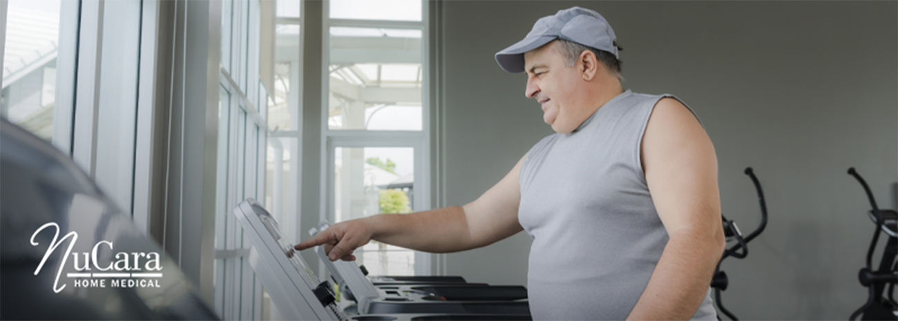 Heavier set man smiling and walking on treadmill
