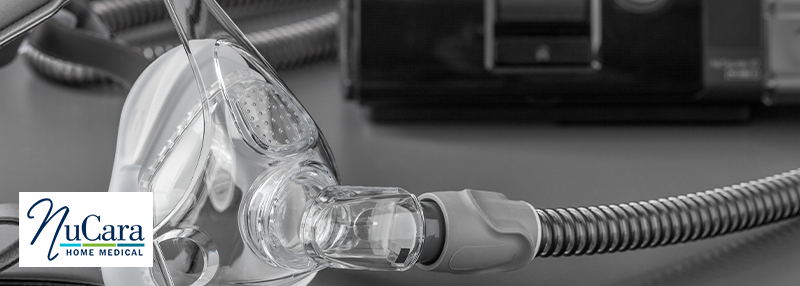 CPAP mask, tubing and CPAP machine in the background of the black and white photo