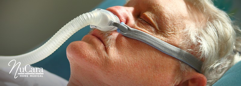 Older man sleeping with a CPAP mask on