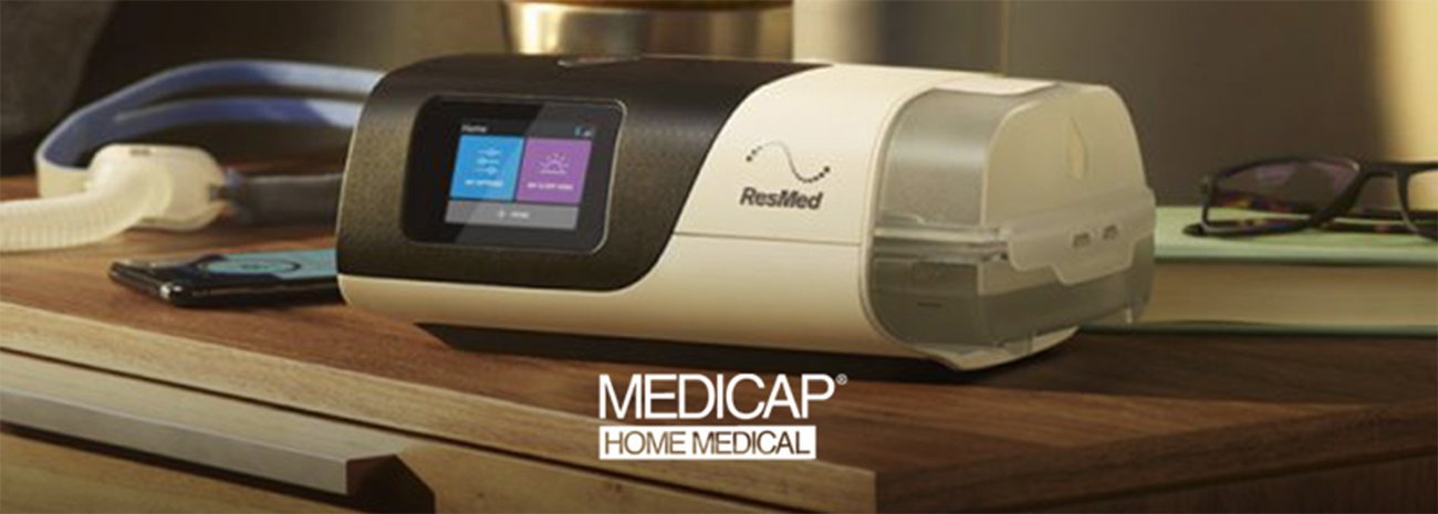 ResMed CPAP machine on bedside table