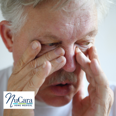 Older man pressing fingers into nose and sinuses to show he is congested