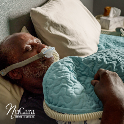 Man asleep in bed with CPAP nasal mask on