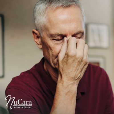 Man pinching the bridge of his nose like he has a headache