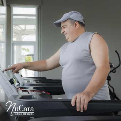 Heavier set man smiling and walking on treadmill