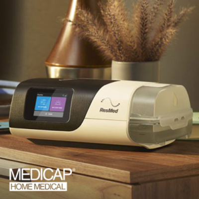 ResMed CPAP machine on bedside table