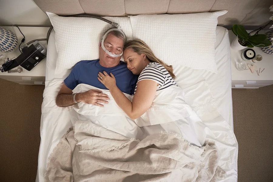 couple sleeping man with cpap